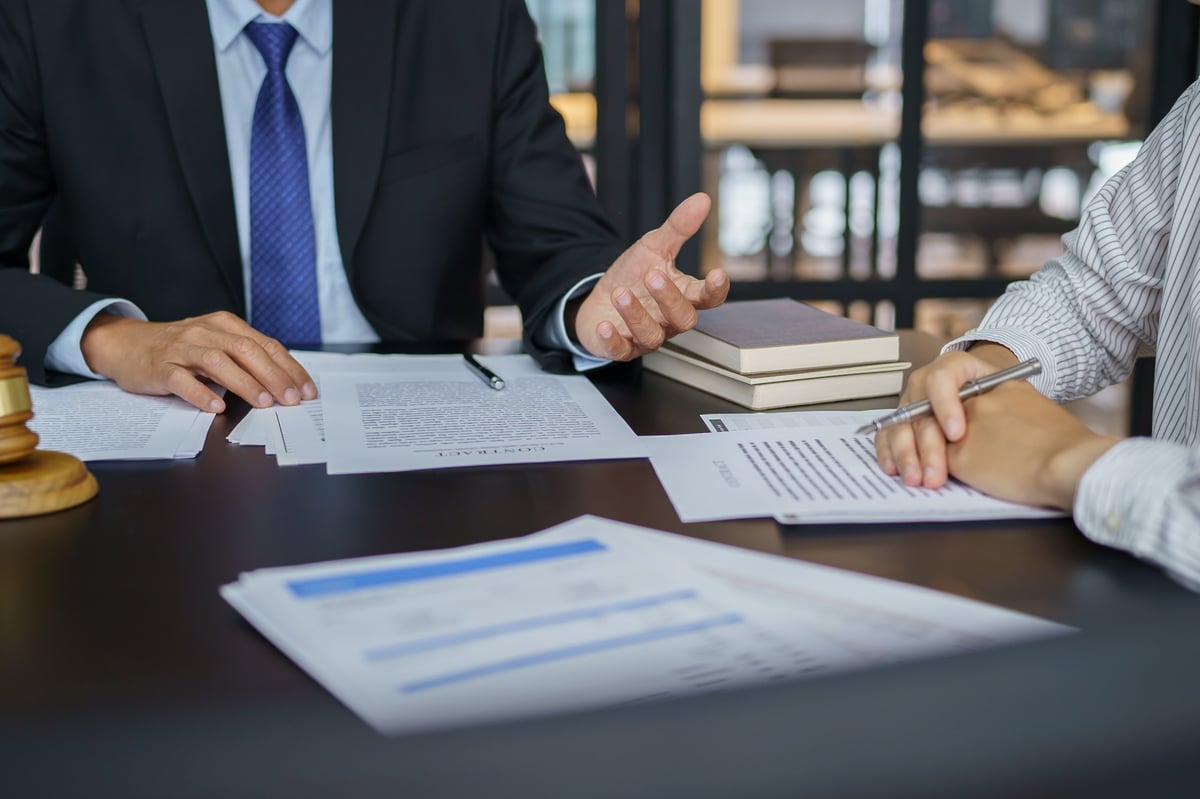 Legal counsel presenting a signed contract