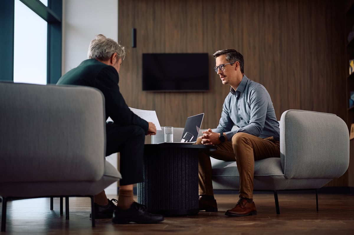 Two executives reviewing business reports together